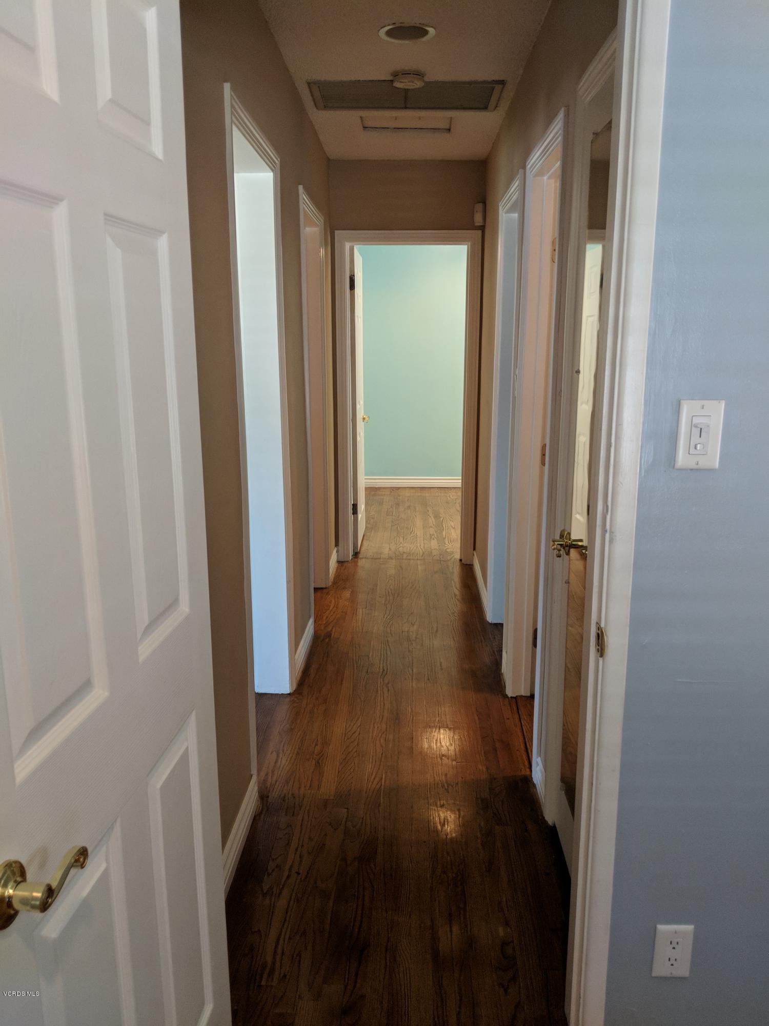 19518 Hart Street Reseda, CA 91335 - Photo 10 of 16 a view of a hallway with a wooden door