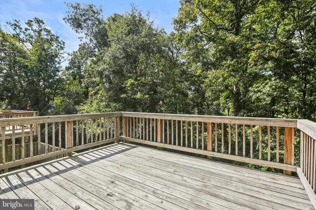 a balcony with wooden floor and fence