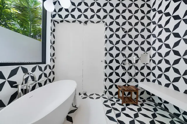 a bathroom with a bathtub and shower