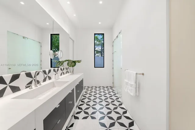 a bathroom with a double vanity sink mirror and double