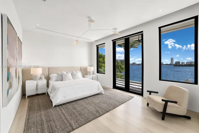 a spacious bedroom with a bed and large couch