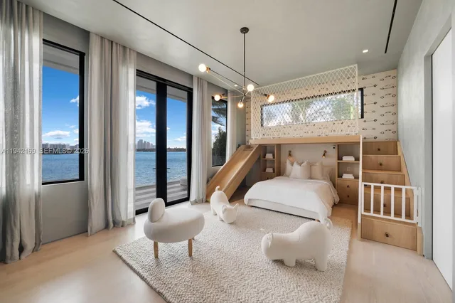 a bedroom with furniture and a large window