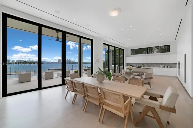 a view of a dining room with furniture large windows and wooden floor