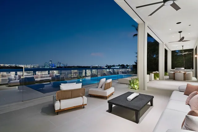 a front view of a house with swimming pool having outdoor seating