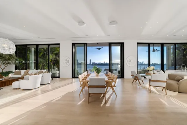 a living room with furniture and large windows