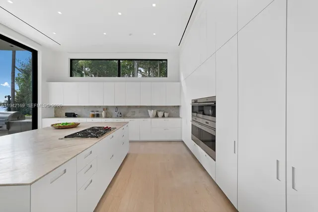 a kitchen with stainless steel appliances granite countertop a stove and a refrigerator