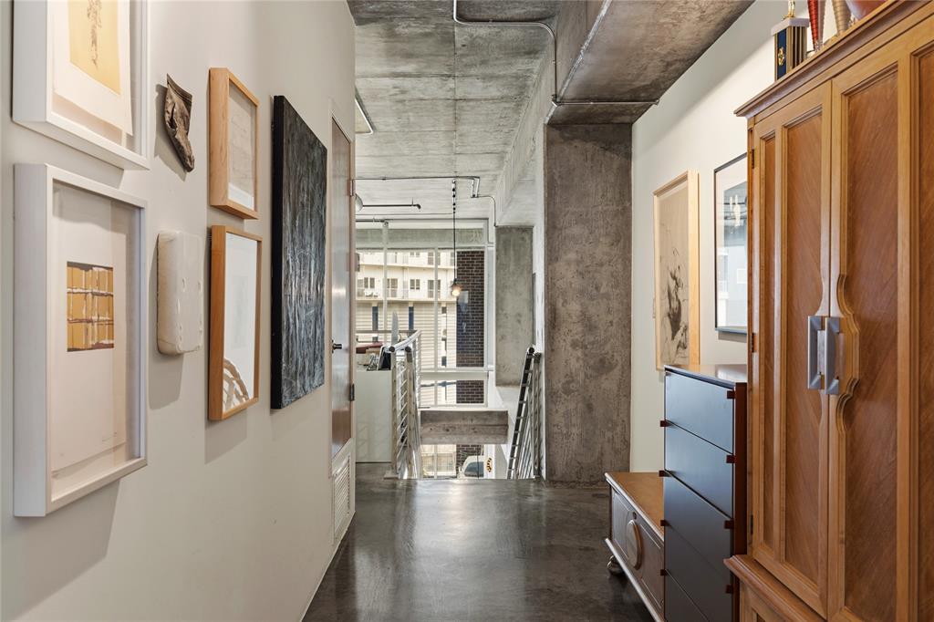 2011 Cedar Springs Road, Unit 305 Dallas, TX 75201 - Photo 16 of 27 Modern industrial hallway featuring concrete ceiling and exposed conduit