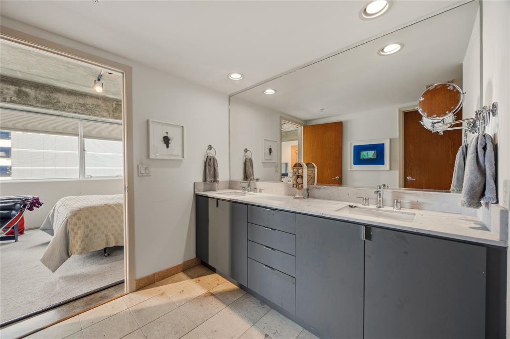 2011 Cedar Springs Road, Unit 305 Dallas, TX 75201 - Photo 22 of 27 Dual vanity featuring undermount sinks and chrome fixtures