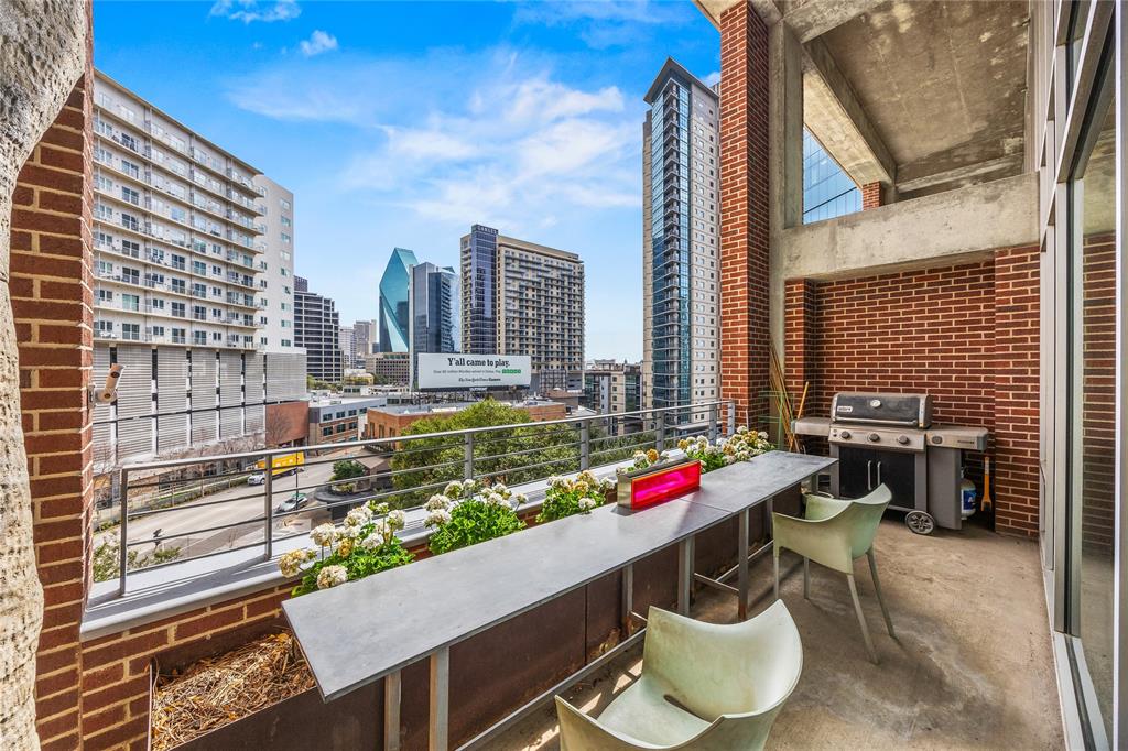 2011 Cedar Springs Road, Unit 305 Dallas, TX 75201 - Photo 24 of 27 Outdoor patio featuring a brick wall, concrete flooring, and metal railing