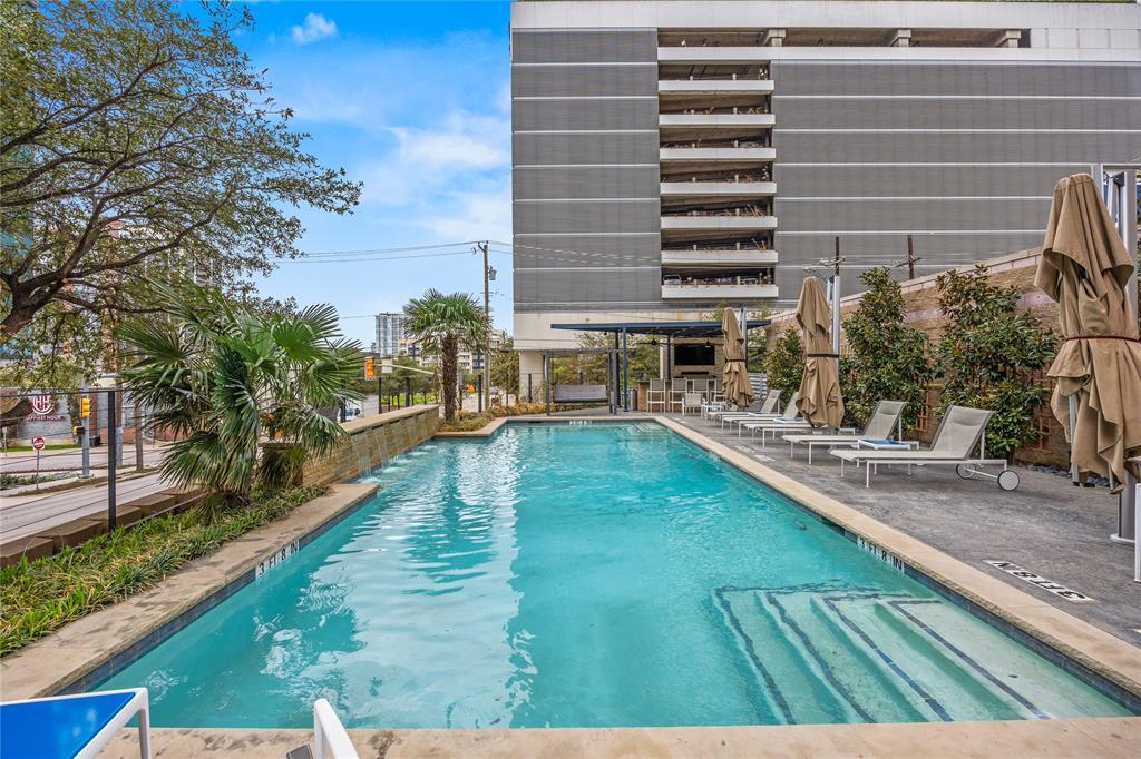 2011 Cedar Springs Road, Unit 305 Dallas, TX 75201 - Photo 26 of 27 Outdoor swimming pool with integrated steps, surrounded by a paved patio and mature landscaping