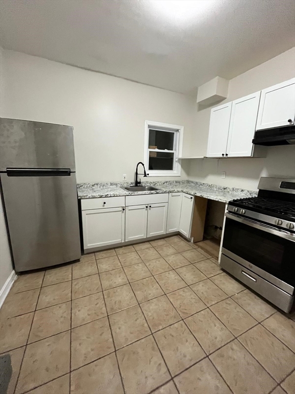 286 Griffin Street, Unit 2 Fall River, MA 02724 - Photo 1 of 9 a kitchen with a stove a sink and a refrigerator