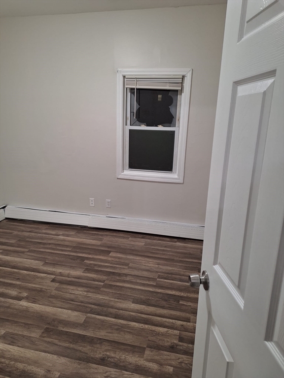286 Griffin Street, Unit 2 Fall River, MA 02724 - Photo 7 of 9 a view of an empty room with wooden floor and a window