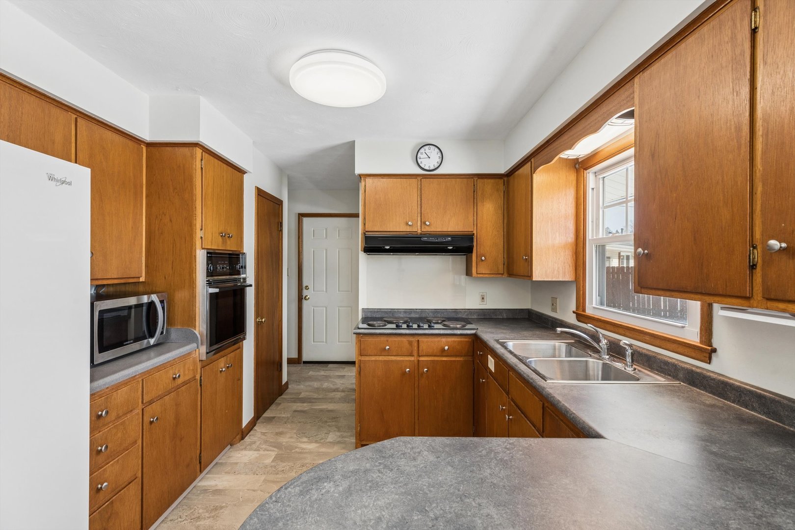 1245 8th Avenue North Clinton, IA 52732 - Photo 11 of 32 a kitchen with stainless steel appliances granite countertop a sink a stove and a refrigerator