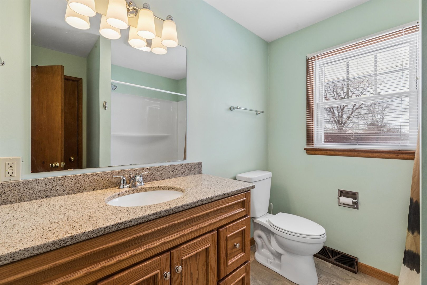 1245 8th Avenue North Clinton, IA 52732 - Photo 22 of 32 a bathroom with a granite countertop sink mirror vanity and toilet