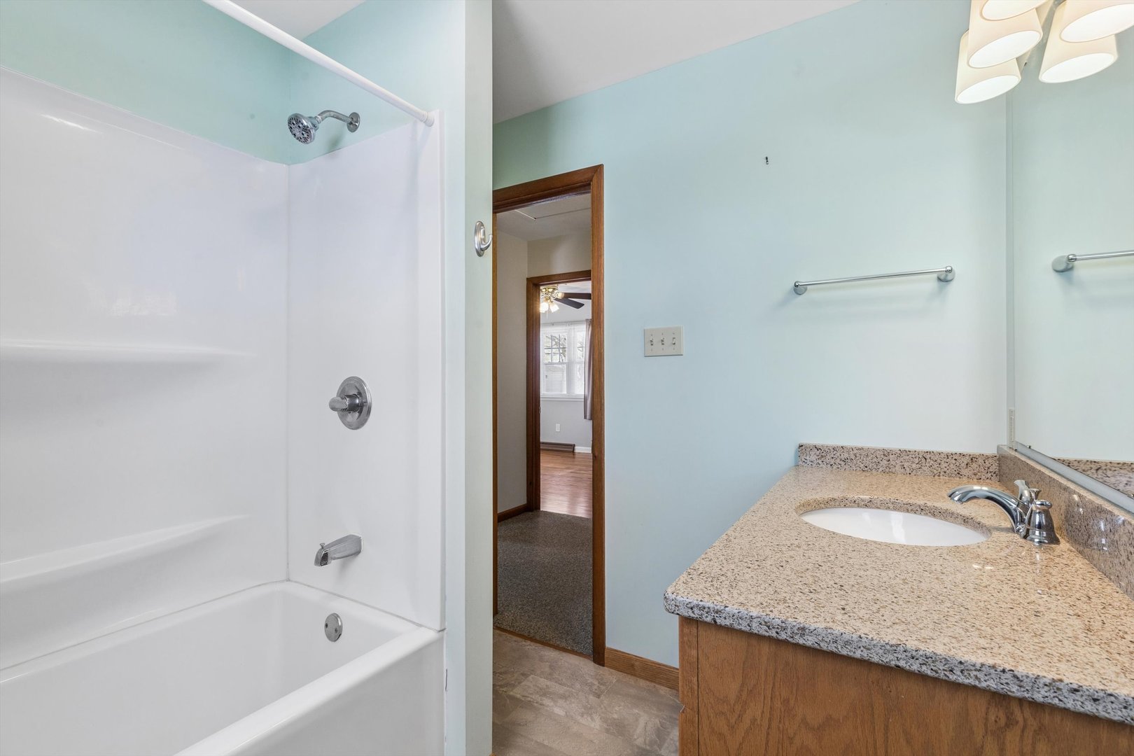 1245 8th Avenue North Clinton, IA 52732 - Photo 23 of 32 a bathroom with a granite countertop sink and mirror with bathtub