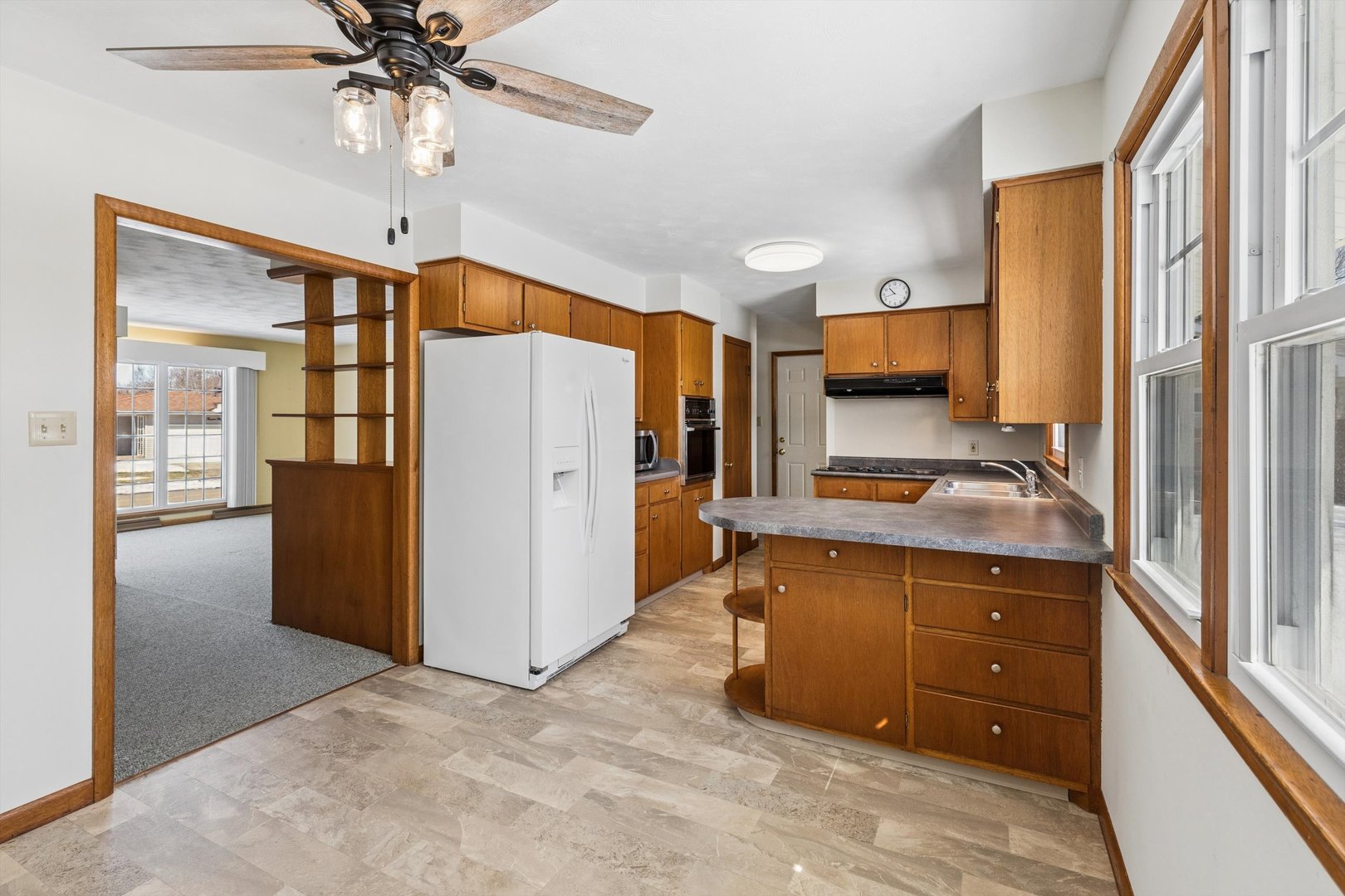 1245 8th Avenue North Clinton, IA 52732 - Photo 10 of 32 a kitchen with stainless steel appliances a refrigerator sink and cabinets
