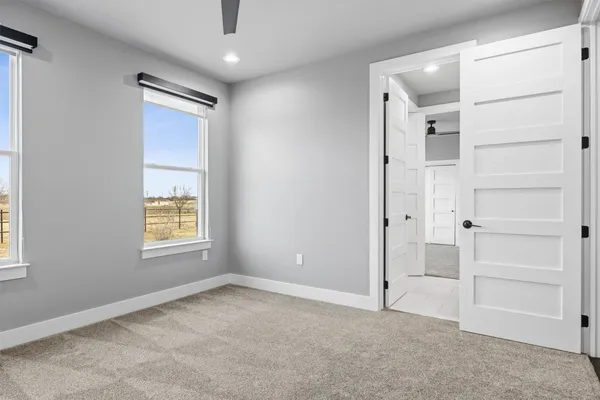 an empty room with windows and closet