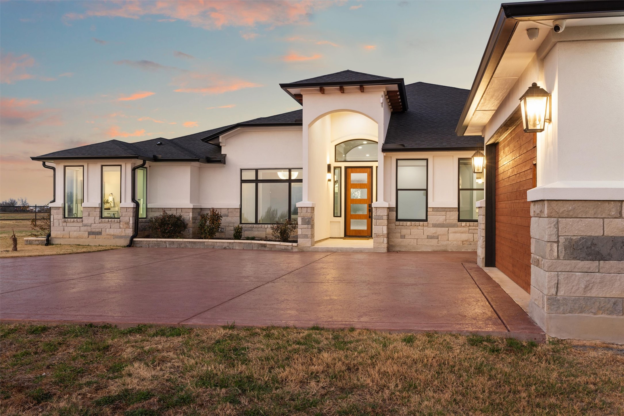 178 Balch Road Elgin, TX 78621 - Photo 2 of 40 View of front of home featuring stone siding, a shingled roof, stucco siding, and a front lawn