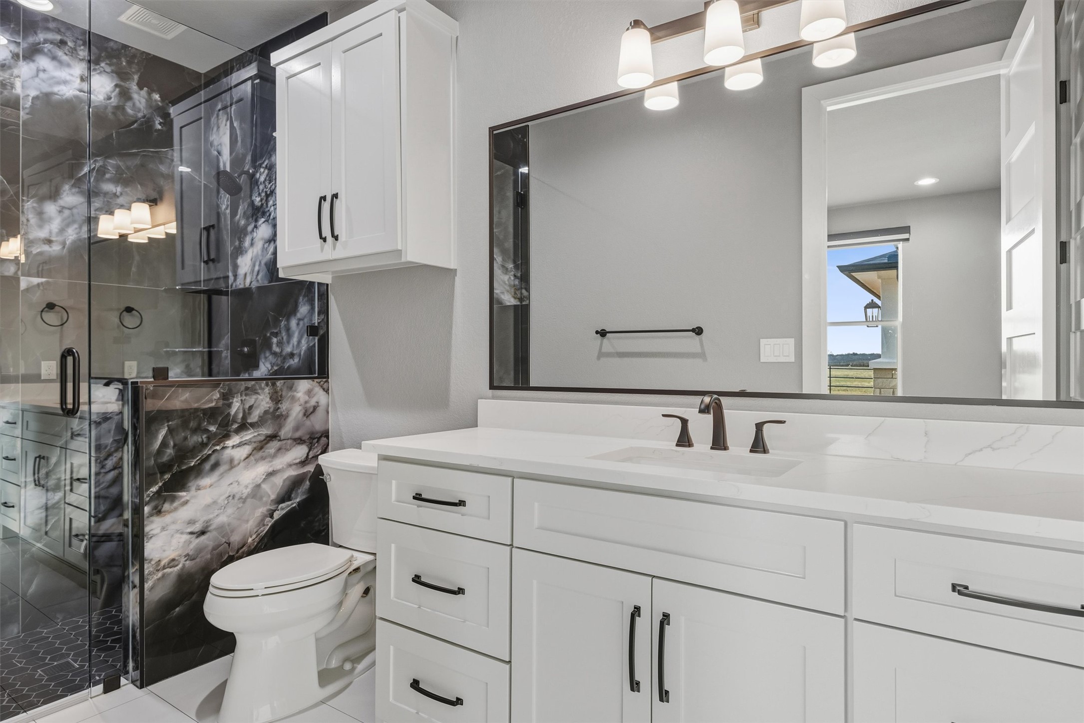 178 Balch Road Elgin, TX 78621 - Photo 27 of 40 Bathroom featuring a marble finish shower, vanity, and tile patterned floors
