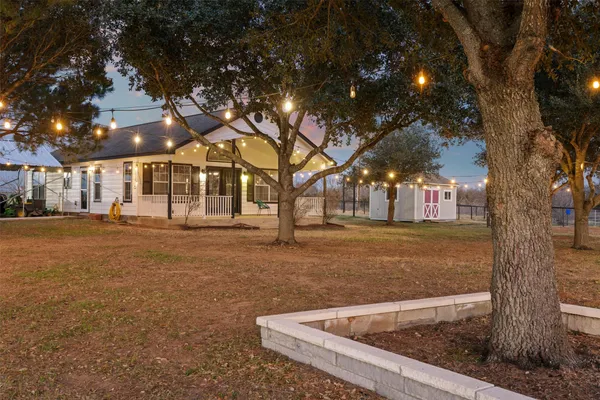 a front view of a house with a garden and yard