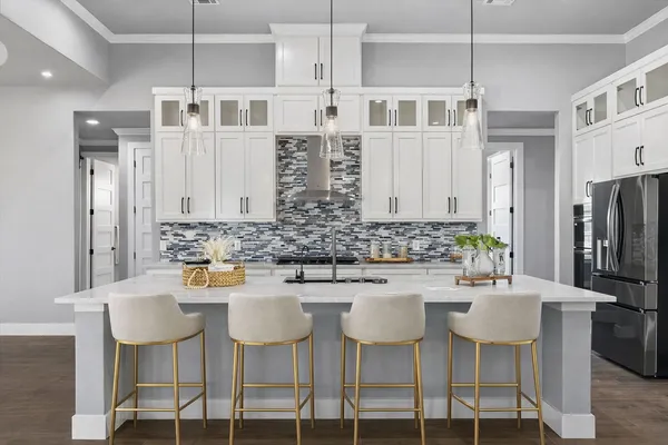 a kitchen with stainless steel appliances kitchen island granite countertop a table and chairs in it