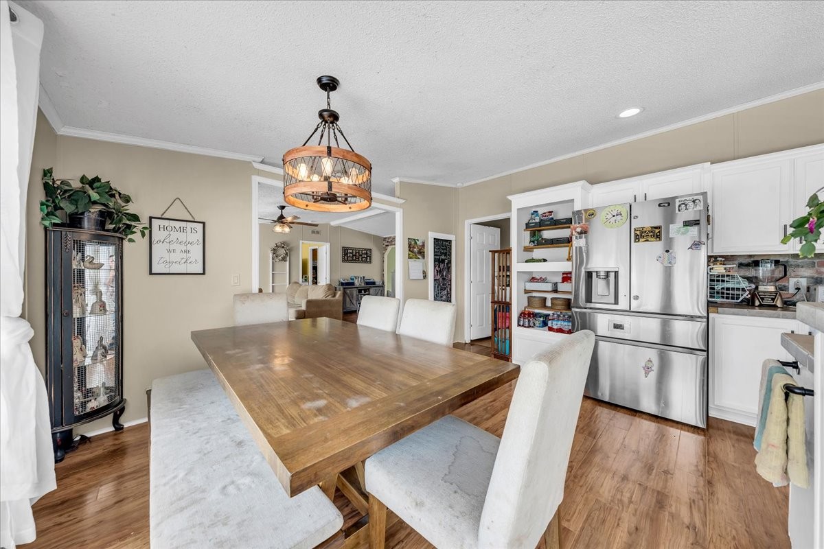 2657 Oak Grove Road Red Boiling Springs, TN 37150 - Photo 23 of 45 a large kitchen with stainless steel appliances granite countertop a stove a refrigerator a dining table and chairs with wooden floor