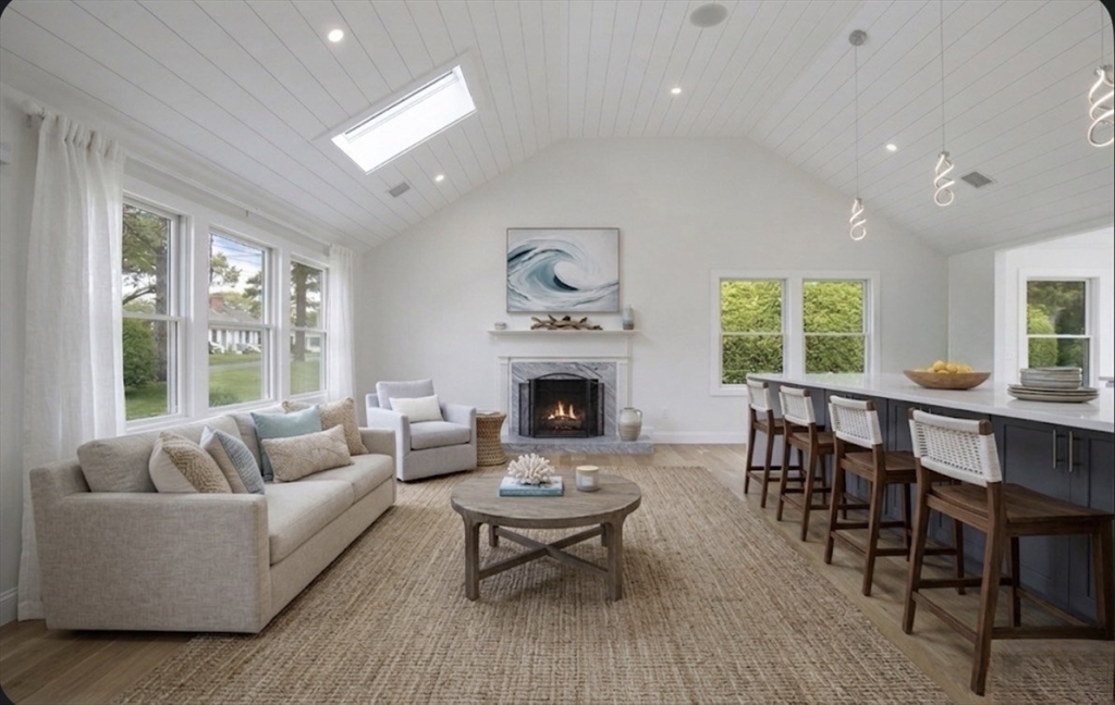200 Sixth Avenue Barnstable, MA 02601 - Photo 6 of 39 a living room with furniture a fireplace and a large window