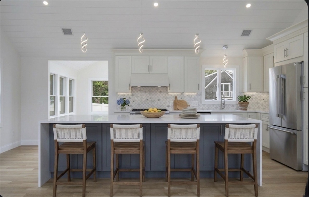 200 Sixth Avenue Barnstable, MA 02601 - Photo 8 of 39 a kitchen with stainless steel appliances a table chairs refrigerator and microwave