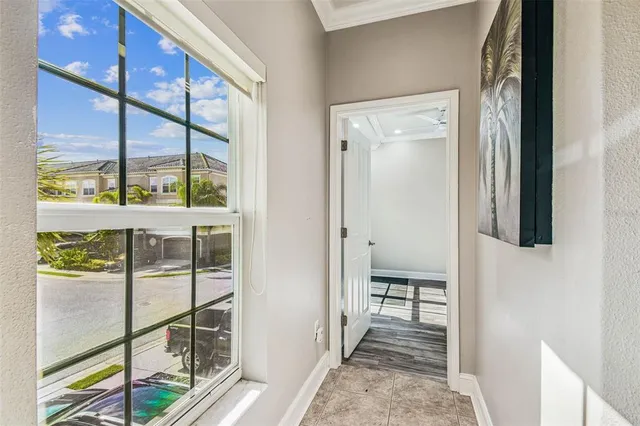 a view of a hallway with wooden floor and a bathroom
