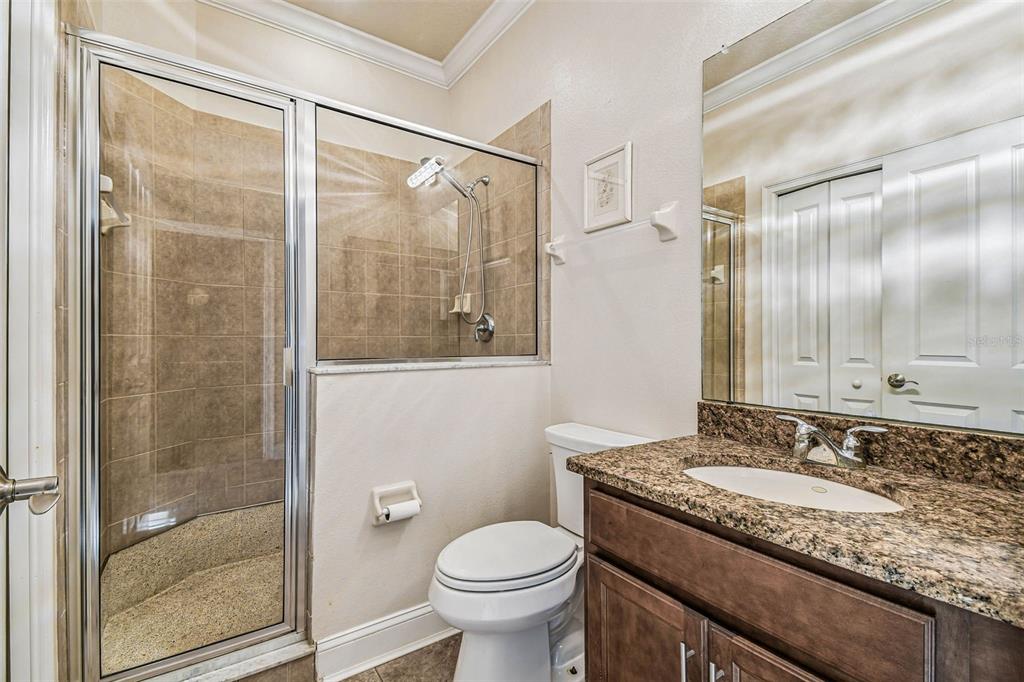 6533 Channelside Drive New Port Richey, FL 34652 - Photo 18 of 44 a bathroom with a granite countertop sink toilet and shower