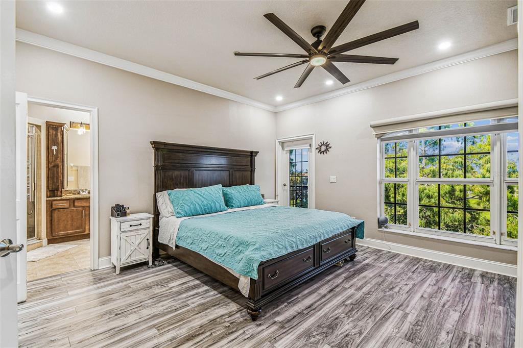 6533 Channelside Drive New Port Richey, FL 34652 - Photo 21 of 44 a room with a bed and a large window with wooden floor