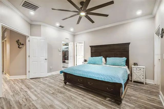a bedroom with a bed and a ceiling fan