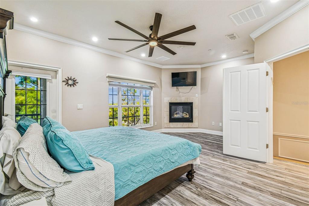 6533 Channelside Drive New Port Richey, FL 34652 - Photo 23 of 44 a bedroom with a bed and a chandelier