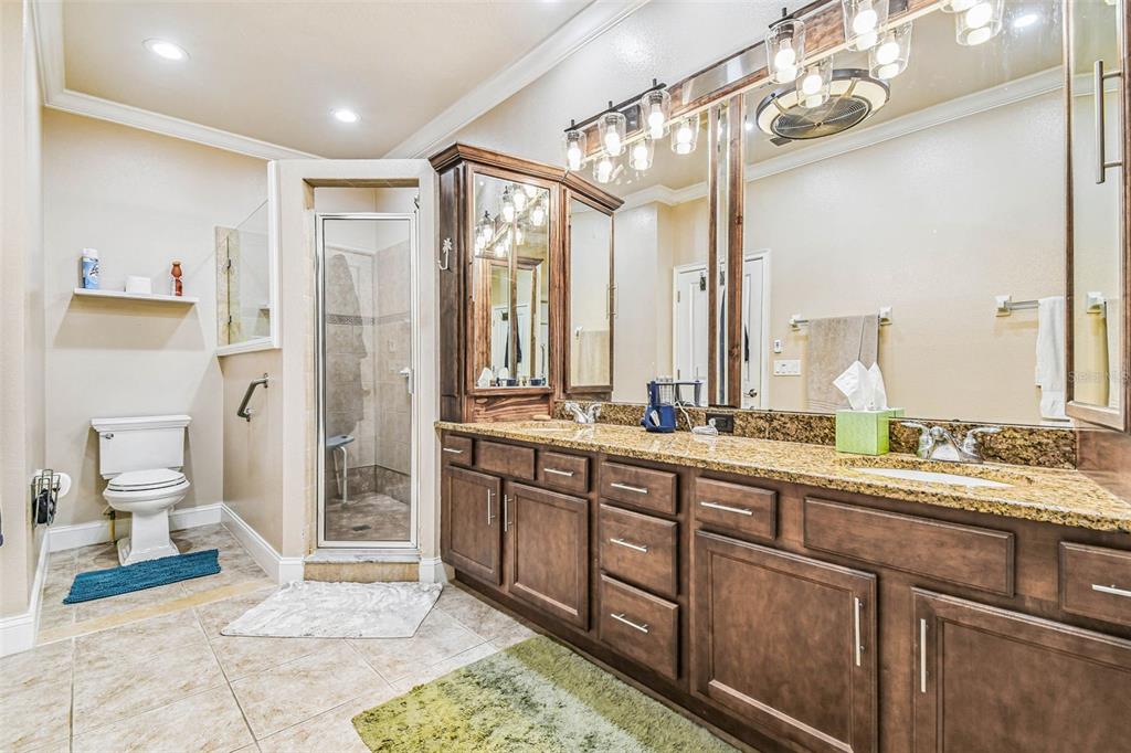6533 Channelside Drive New Port Richey, FL 34652 - Photo 25 of 44 a spacious bathroom with a double vanity sink a mirror and a shower
