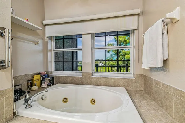 a bathroom with a tub and a window