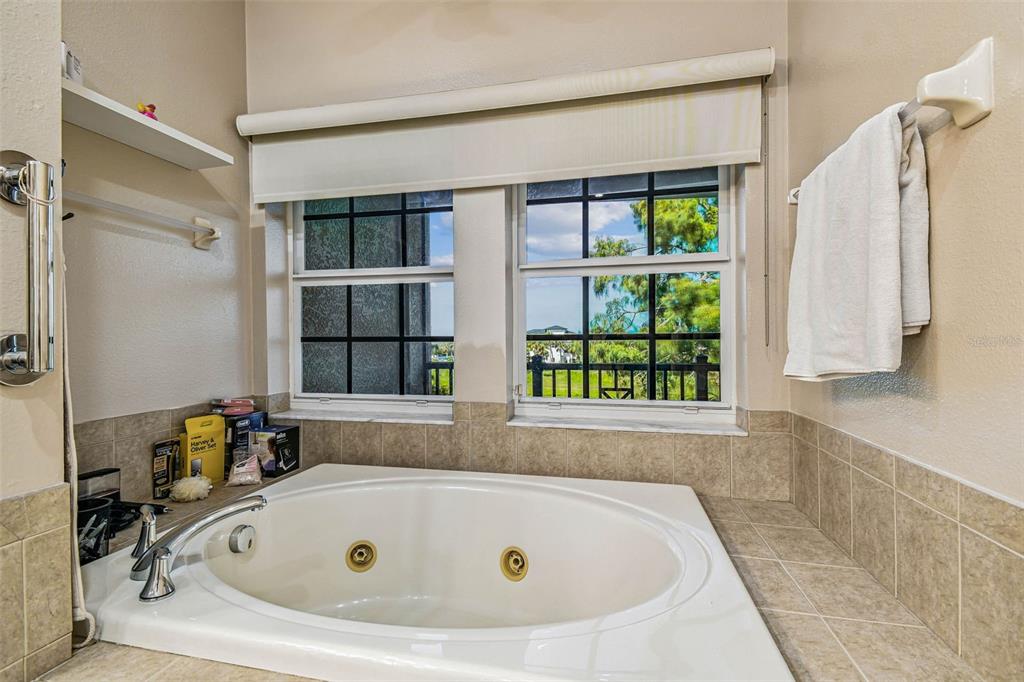 6533 Channelside Drive New Port Richey, FL 34652 - Photo 27 of 44 a bathroom with a tub and a window