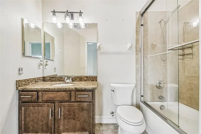 a bathroom with a sink toilet vanity and shower