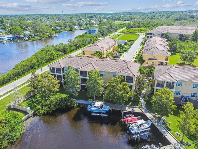 an aerial view of a house with outdoor space and lake view