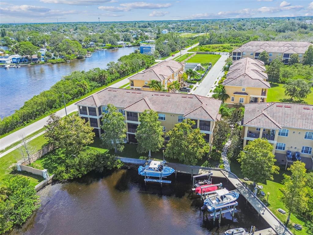 6533 Channelside Drive New Port Richey, FL 34652 - Photo 36 of 44 an aerial view of a house with outdoor space and lake view