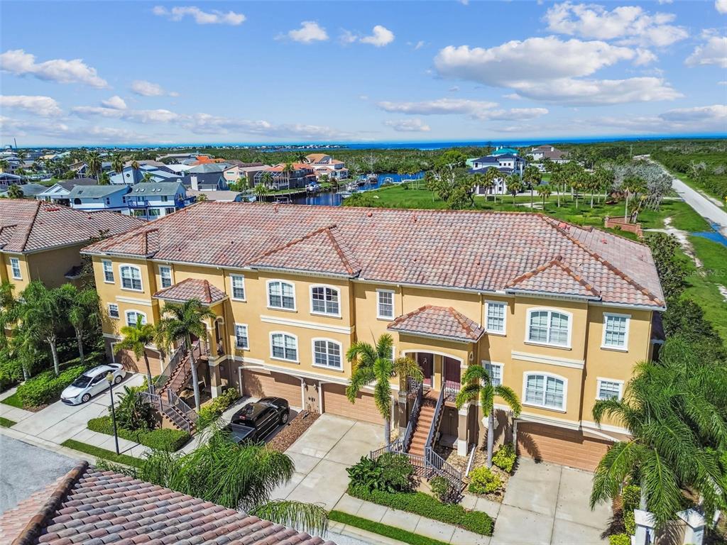 6533 Channelside Drive New Port Richey, FL 34652 - Photo 38 of 44 a front view of a residential apartment building with a yard