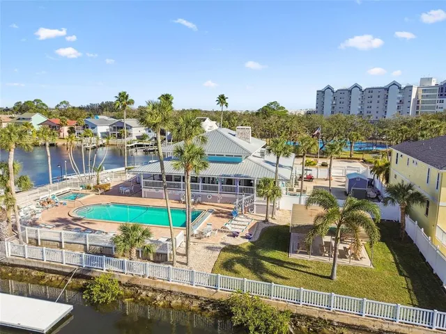 a view of a swimming pool with outdoor seating and a patio