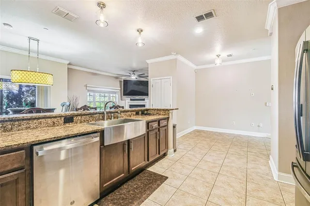 a kitchen with stainless steel appliances granite countertop a sink a stove and a refrigerator