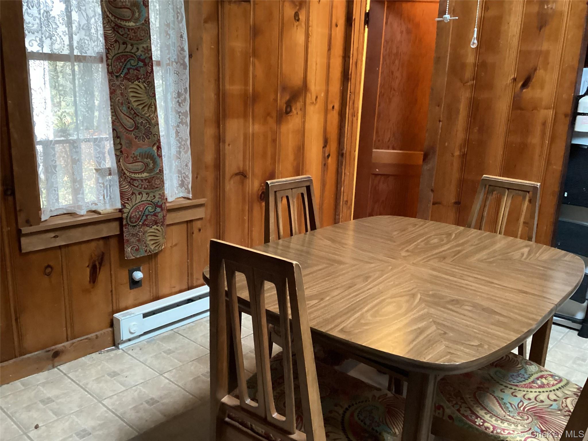 302 Todd Road, Unit T Woodbourne, NY 12788 - Photo 10 of 14 a view of a dining room with furniture and window