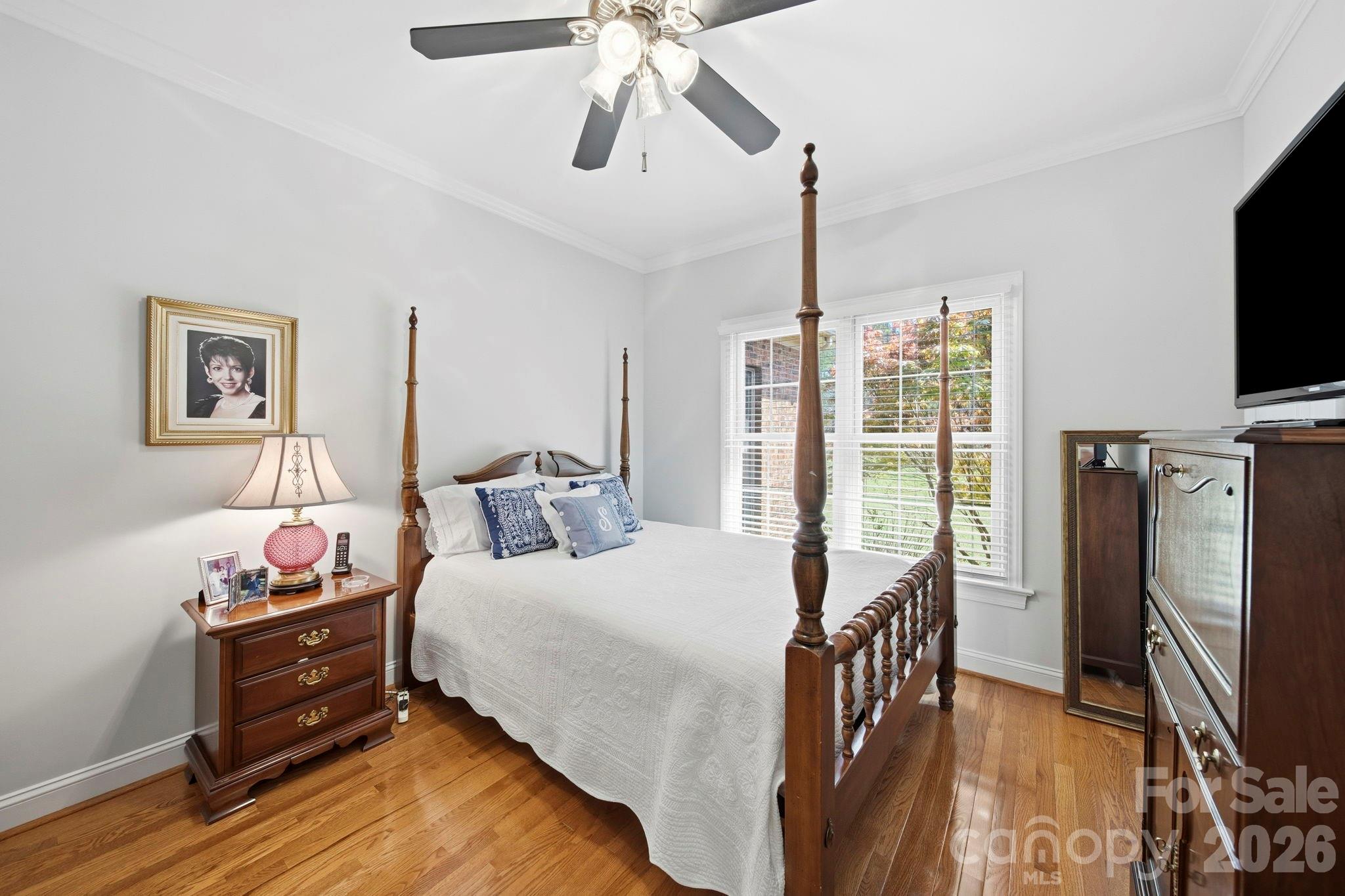 2909 Lakeshore Drive Chester, SC 29706 - Photo 37 of 44 a bedroom with a bed a flat screen tv and a chandelier