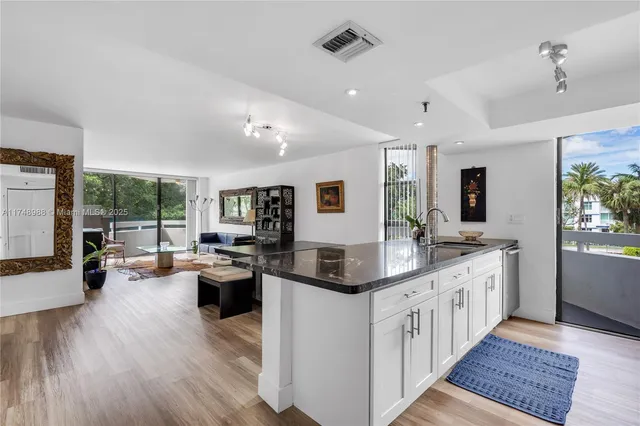 a kitchen with lots of counter space and painting on the wall