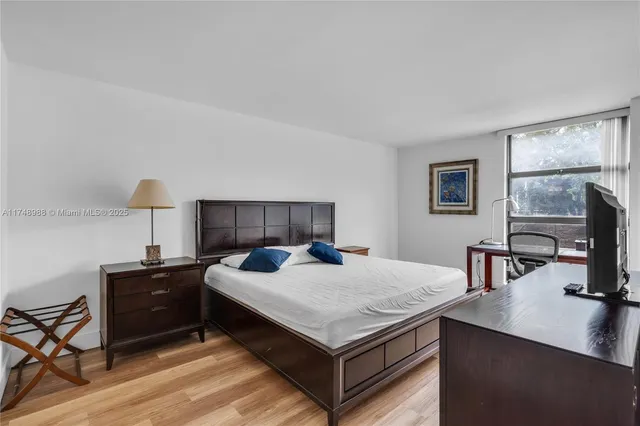 a bedroom with a bed and a table in it