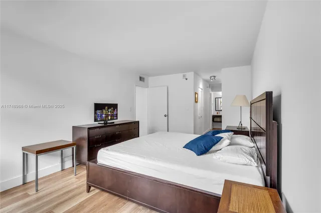 a bedroom with a bed and a tv