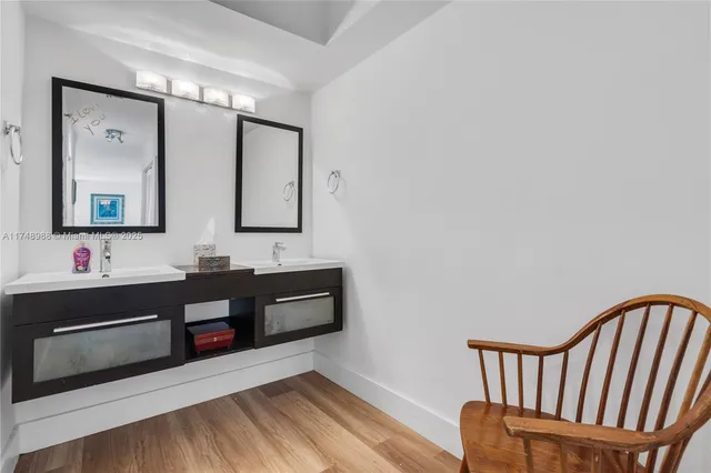 a bathroom with a bathtub a mirror and a sink