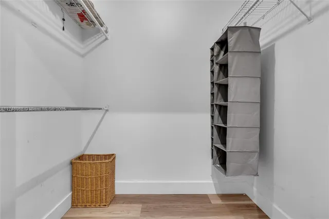 a view of walk in closet with empty racks