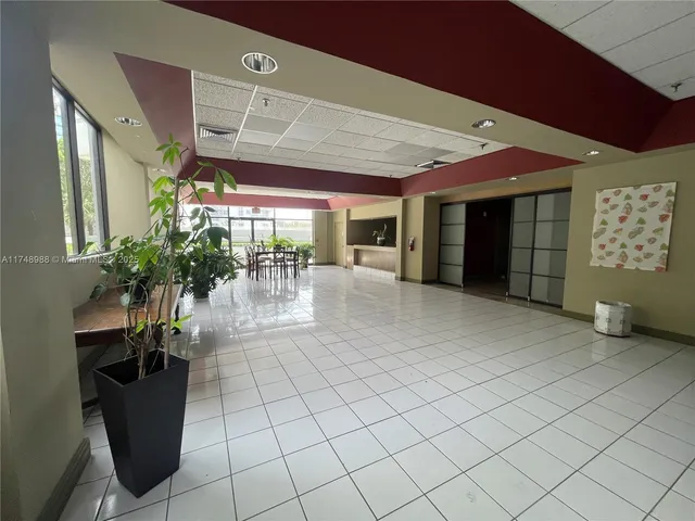a lobby with furniture and a potted plant